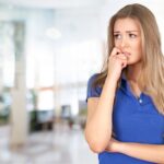 a girl in blue shirt thinking of the best way to reduce anxiety